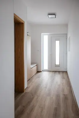 an empty room with white walls and wooden floors at Holiday Home Kamence in Rogaška Slatina
