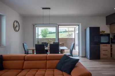 a living room with a couch and a table at Holiday Home Kamence in Rogaška Slatina