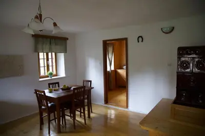 a dining room with a table and chairs and a door at Vintage Lake House Bohinj in Bohinj