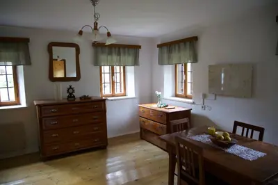 a kitchen with a table and a dresser with a mirror at Vintage Lake House Bohinj in Bohinj