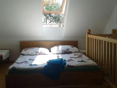 a bed with a blue object on it in a bedroom at Holiday home with 2 bedrooms in Zgornja Kungota