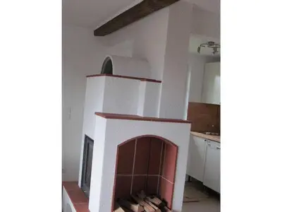 a fireplace in the middle of a kitchen at Holiday home with 2 bedrooms in Zgornja Kungota