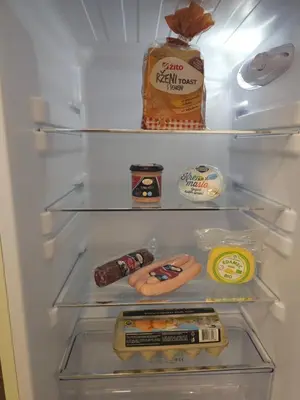 an open refrigerator with food and a bottle of food at Vila Hrastnica in Škofja Loka