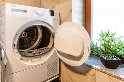 a washer and dryer sitting next to a window at Vila Hrastnica in Škofja Loka