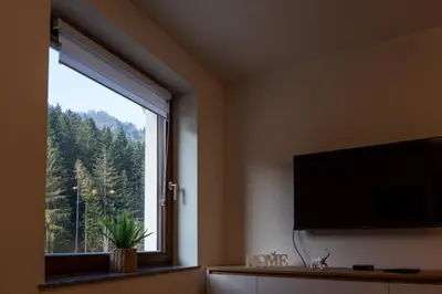 a room with a large window with a flat screen tv at Vila Hrastnica in Škofja Loka