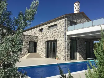 a stone house with a swimming pool in front of it at Luxury in Perfect Location, Sežana Villa 1003 in Sežana