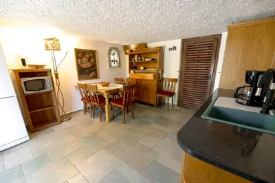 a kitchen and dining room with a table and chairs at Vineyard cottage Rustika in Novo Mesto