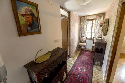a hallway with a painting of a man on the wall at Vineyard cottage Rustika in Novo Mesto