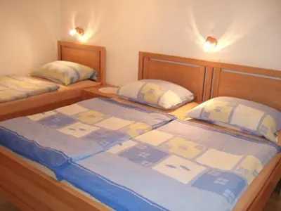 a bedroom with two twin beds and two lamps at Sobe Cvetek in Bohinj
