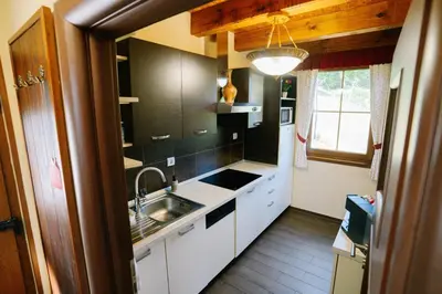 a kitchen with white cabinets and a sink and a window at Brioni Hills - Premium Escape in Šmarje pri Jelšah