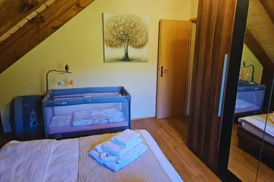 a bedroom with a bed and a tree picture on the wall at Brioni Hills - Premium Escape in Šmarje pri Jelšah