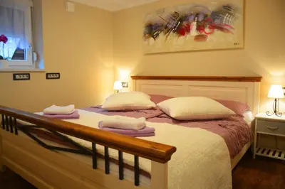 a bedroom with a bed with two towels on it at Apartment Arpa in Ljubljana