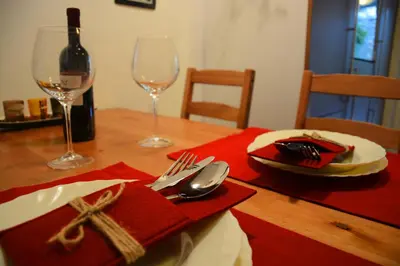 a table with a bottle of wine and two wine glasses at Apartment Arpa in Ljubljana