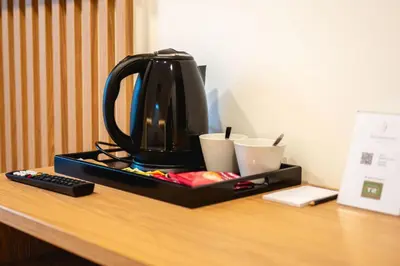 a black tea kettle sitting on top of a desk at Vineyard Escape Herbersteinova klet in Juršinci