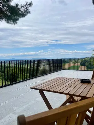 a wooden picnic table sitting on top of a patio at Vineyard Escape Herbersteinova klet in Juršinci