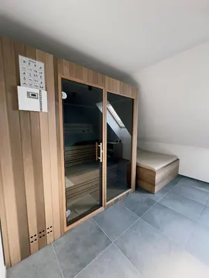 a room with wooden cabinets and a bed at Vineyard Escape Herbersteinova klet in Juršinci