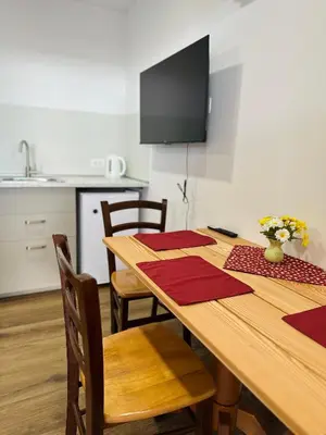 a wooden table with red napkins on it in a kitchen at Stara Žaga in Bled
