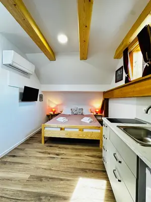 a kitchen with a bed in the middle of a room at Stara Žaga in Bled