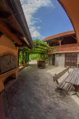 a bench sitting in the courtyard of a building at Zidanica Krošelj in Raka