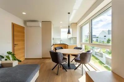 a kitchen and dining room with a table and chairs at Sunny Green Escape in Lesce
