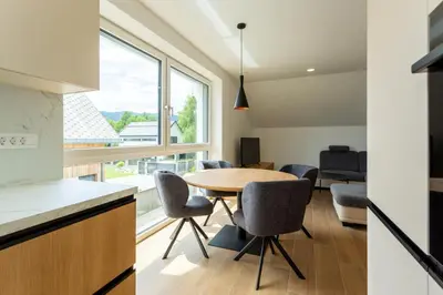 a kitchen and dining room with a table and chairs at Sunny Green Escape in Lesce