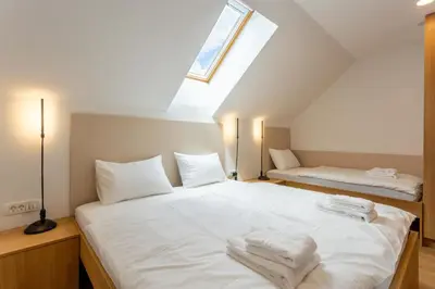 a bedroom with a bed with white sheets and a window at Sunny Green Escape in Lesce