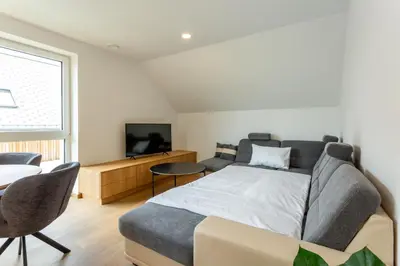 a bedroom with a bed and a tv and a table at Sunny Green Escape in Lesce