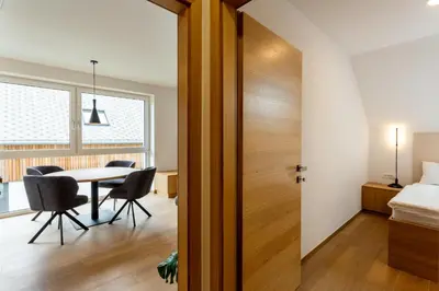 a room with a table and chairs and a bed at Sunny Green Escape in Lesce