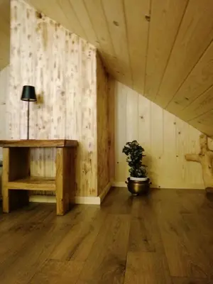 a room with a table and a potted plant at Hiša pod Rogatcem - studio in Luče