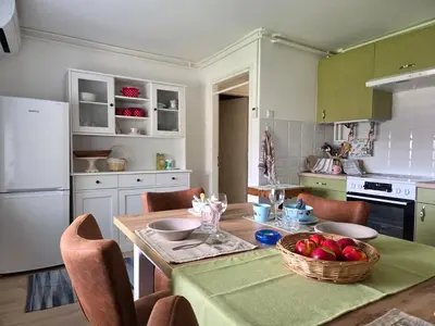 a kitchen with a table with a bowl of apples on it at Cozy Apartment Adriana in Spodnji Duplek