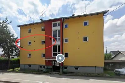 a yellow building with a red circle in front of it at Cozy Apartment Adriana in Spodnji Duplek