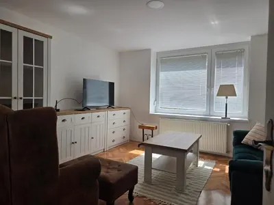 a living room with a couch and a tv and a table at Cozy Apartment Adriana in Spodnji Duplek