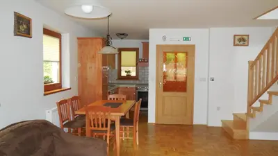 a kitchen and dining room with a table and chairs at Apartments Savinja in Luče