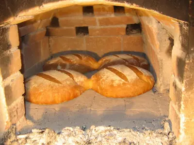 two loaves of bread in a brick oven at Apartments Savinja in Luče