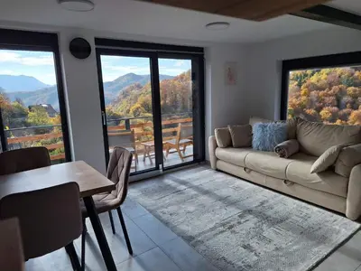 a living room with a couch and a table at En hribček in Ptujska Gora