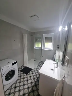 a bathroom with a washing machine and a sink at Vipava Valley Stay - Apartment Miki - With Patio, Parking & Pets OK in Ajdovščina