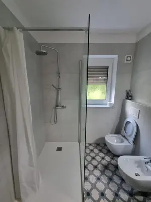 a bathroom with a shower and a toilet and a sink at Vipava Valley Stay - Apartment Miki - With Patio, Parking & Pets OK in Ajdovščina