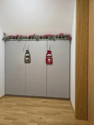 a couple of white doors with red bags on them at Hiška Maša in Čatež ob Savi