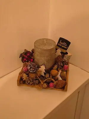 a candle sitting on top of a table with shells at Hiška Maša in Čatež ob Savi