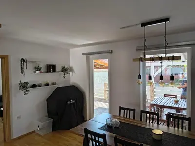 a kitchen and dining room with a table and a dining room at Hiška Maša in Čatež ob Savi