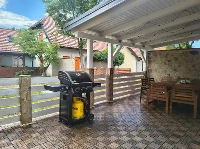a gas grill sitting on a patio with a house at Hiška Maša in Čatež ob Savi