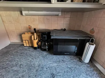 a kitchen with a microwave and a coffee maker at Hiška Maša in Čatež ob Savi