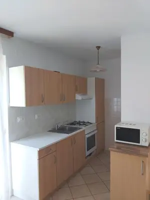 a kitchen with a sink and a stove top oven at Apartments Petrin in Tolmin