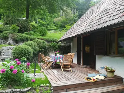 a wooden deck with a table and chairs on it at Chalet Iskaretreat in Ig