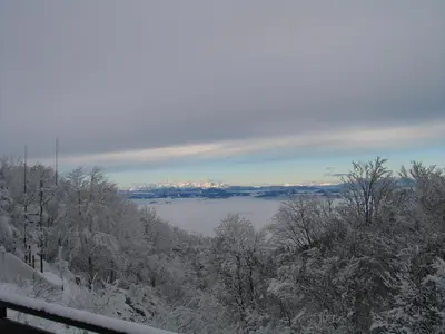 a view of a valley with snow covered trees and clouds at Chalet Iskaretreat in Ig