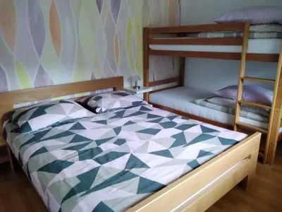 a bedroom with two bunk beds and a bed at Apartment Zadraga in Tolmin