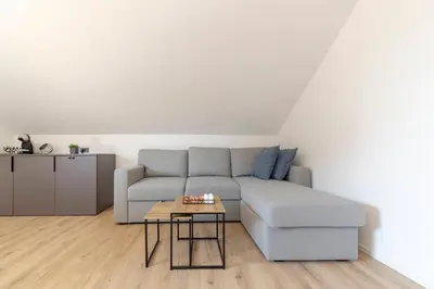 a living room with a couch and a table at Yellow and Green apartments in Ljubljana