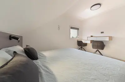 a bedroom with a bed with two pillows on it at Yellow and Green apartments in Ljubljana