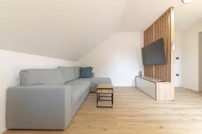 a living room with a couch and a flat screen tv at Yellow and Green apartments in Ljubljana