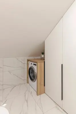 a washer and dryer in a room with white walls at Yellow and Green apartments in Ljubljana